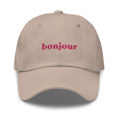 bonjour-au-revoir-classic-dad-cap in Pink Classic dad cap with embroidered witty quote – Stay Witty classic baseball hat with adjustable strap and curved brim.